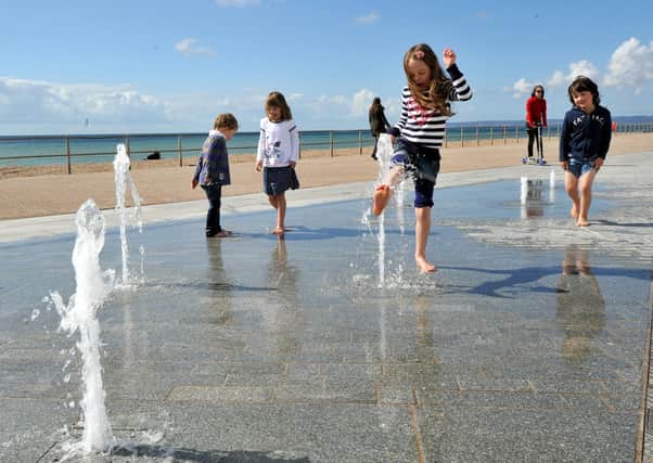 Children enjoying the fountains soon after they opened