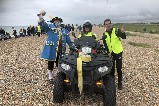 Worthing town crier Bob Smytherman and head teacher Pete Byrne with the beach patrol