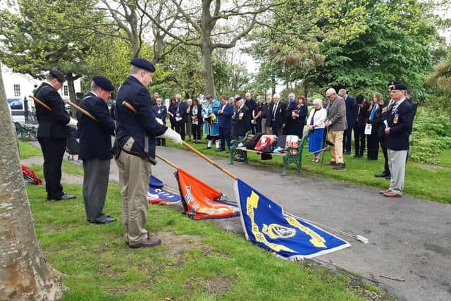 Standards are lowered during the service to mark the 105th anniversary of the Battle of the Boar’s Head