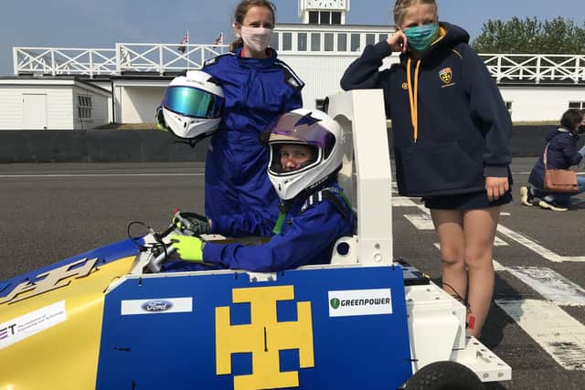 Cranleigh Prep School pupils Lucinda Leaver, Anise Robinson and Annabel Evelyn at Goodwood with the go-kart they made with their classmates