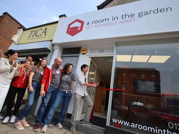 Councillor Robert Nemeth cuts the ribbon for the official opening of A Room in the Garden's offices in Boundary Road