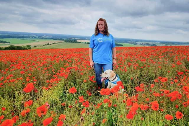 Teresa Williams with Oscar, ending their sponsored dog walk for Cancer Research UK on a high in a stunning poppy field in Chichester