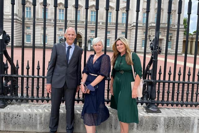 Left to right: Ian Puttock, Michelle Butler and Amber Perrin outside Buckingham Palace. SUS-210607-111115001