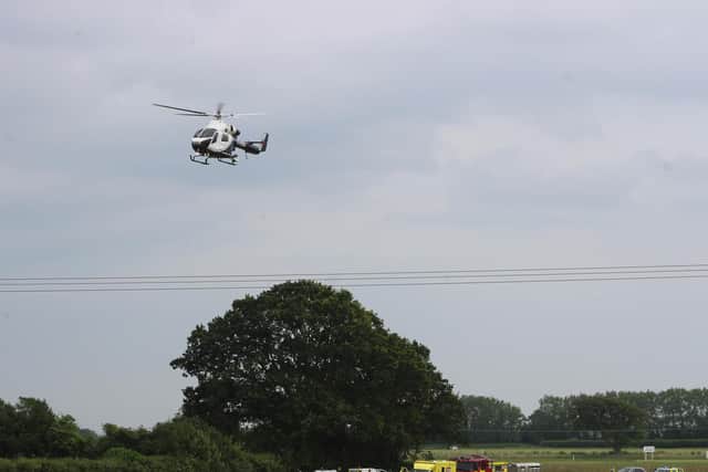 An air ambulance arrives at the scene of the crash on Wednesday. Picture by Eddie Mitchell