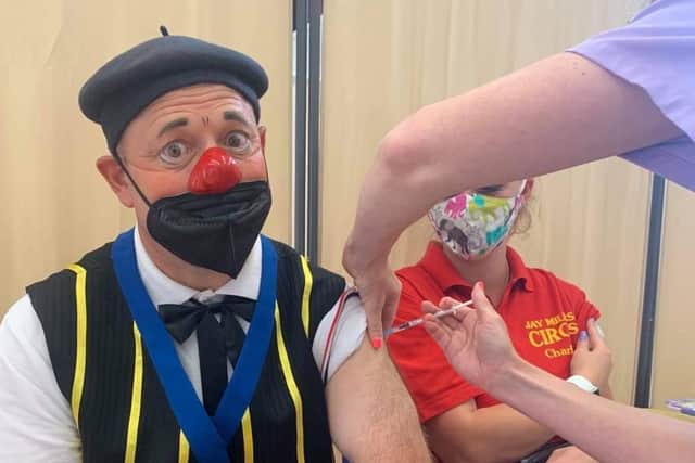 Peppi the clown from Jay Miller's Circus gets his Covid jab at Clair Hall, Haywards Heath.