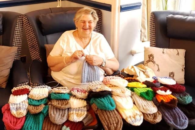 Valerie Margodt is knitting constantly, making hats and scarves for the homeless
