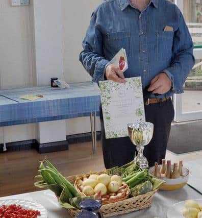 Bob Rogers won the Challenge Cup for best exhibit in the fruit and veg classes for his basket of vegetables