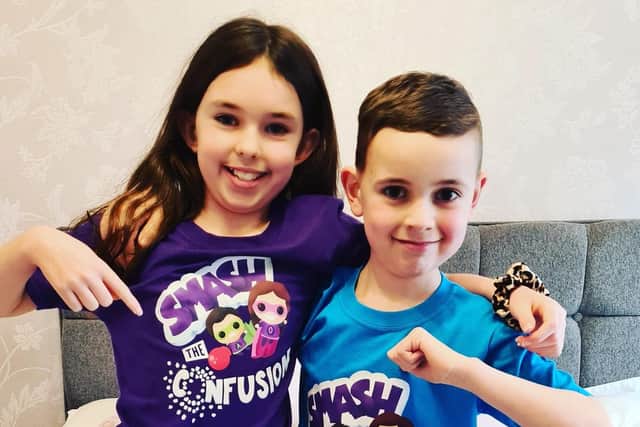 Olivia and Adam wearing Smash The Confusion t-shirts, developed by their mum's company Waking Up To Autism