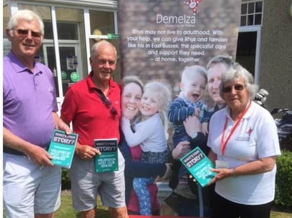 Pam Robinson, volunteer fundraiser for Demelza, Paul Roberts (red shirt), senior captain, and Mel Lockett with the book “What’s Your Story?” that is netting funds for Demelza Hospice