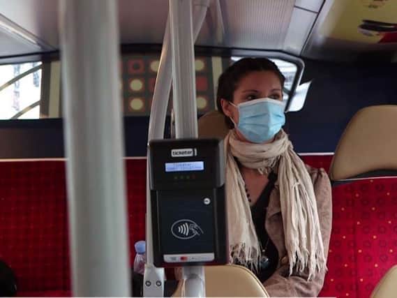 The bus company is asking passengers to continue wearing face coverings if they can