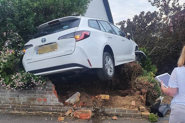 Car leaves road and crashes into garden wall in Lancing