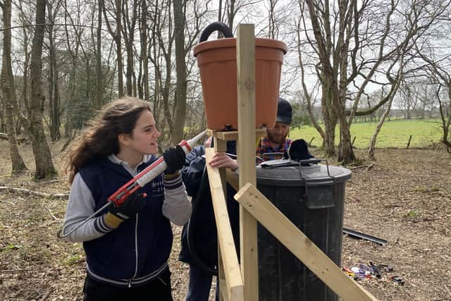 An Atelier 21 pupil making an outdoor water storage system