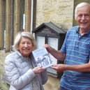 Phil Dennett presents Cuckfield Museum steward Kate Fleming with a copy of his book.