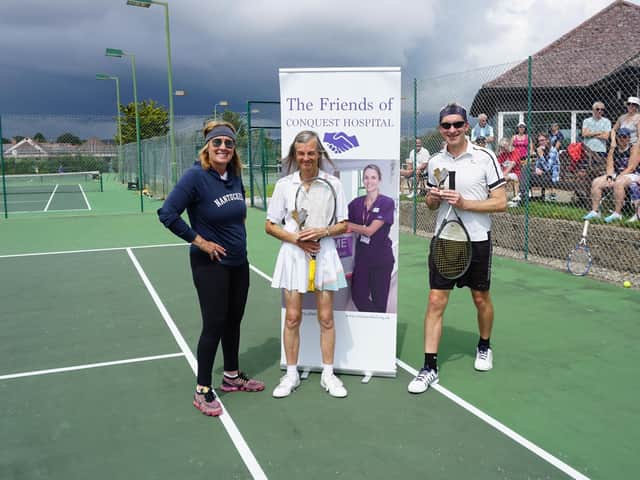 Sheila King and Robert Millington are presented with the winners' trophy by Sarah Kowitz
