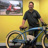 Greg Jones with the e-bikes proposed for rental. SUS-210730-094135001