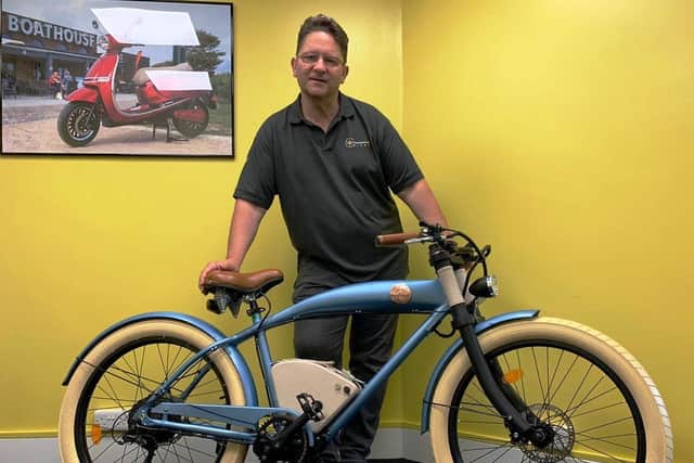 Greg Jones with the e-bikes proposed for rental. SUS-210730-094135001