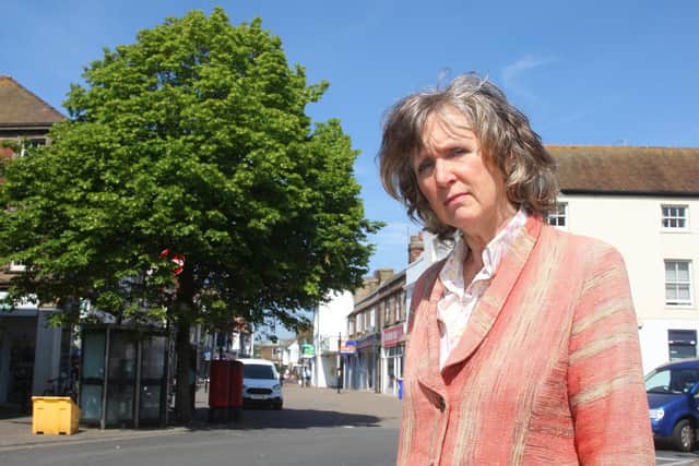 Chistine Wiltshire beside a lime tree in High Street, Littlehampton which has been saved from being cut down by the council. Photo by Derek Martin Photography.