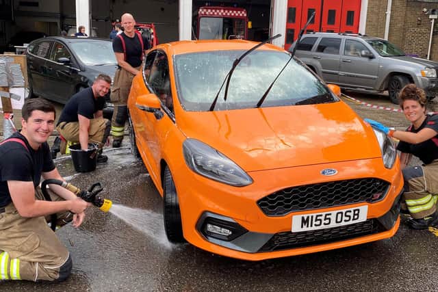 Haywards Heath firefighters washed more than 100 cars to raise funds for The Fire Fighters Charity SUS-210408-144943001