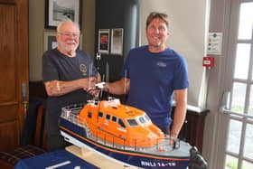 Swiss Cottage Model Boat Club vice-president Robert Rice presents the model lifeboat he made to former Shoreham RNLI coxswain Steve Smith. Photo by Derek Martin DM21081102a