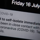 A notification issued by the NHS coronavirus contact tracing app - informing a person of the need to self-isolate immediately, due to having been in close contact with someone who has coronavirus - is displayed on a mobile phone in London, during the easing of lockdown restrictions in England.
