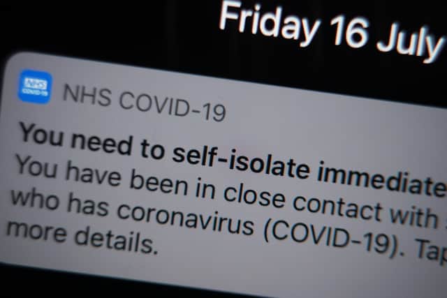 A notification issued by the NHS coronavirus contact tracing app - informing a person of the need to self-isolate immediately, due to having been in close contact with someone who has coronavirus - is displayed on a mobile phone in London, during the easing of lockdown restrictions in England.