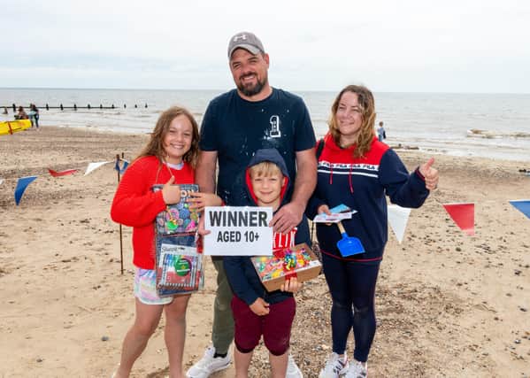 Lily and Fred, winners of the aged ten and over category at the sandcastle competition with their prizes in Littlehampton. Photo by Scott Ramsey