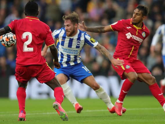 Alexis Mac Allister takes on the Getafe defence at the Amex Stadium