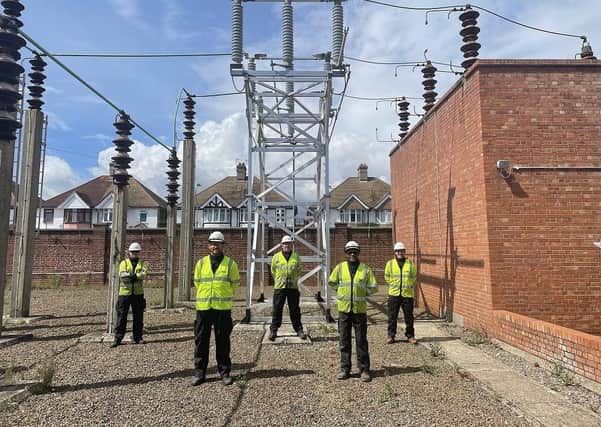 Eastbourne power upgrade. One of the new switches in Eastbourne with some of the team that helped deliver the investment. SUS-210908-125810001
