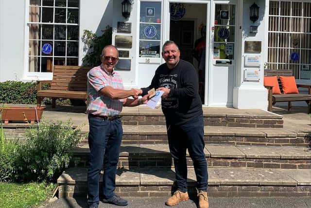 Oliver Sterno of Plastic Free Eastbourne presents Karl Hopper-Young of Sussex Independent Financial Advisers a Plastic Free Champion certificate SUS-211208-094446001