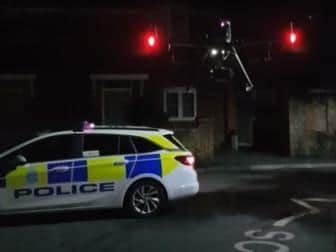A police car and the drone at the scene. Picture courtesy of Sussex Police