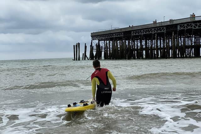 A lifeguard heads out as part of the rescue. Picture from John Bownas SUS-210818-103803001