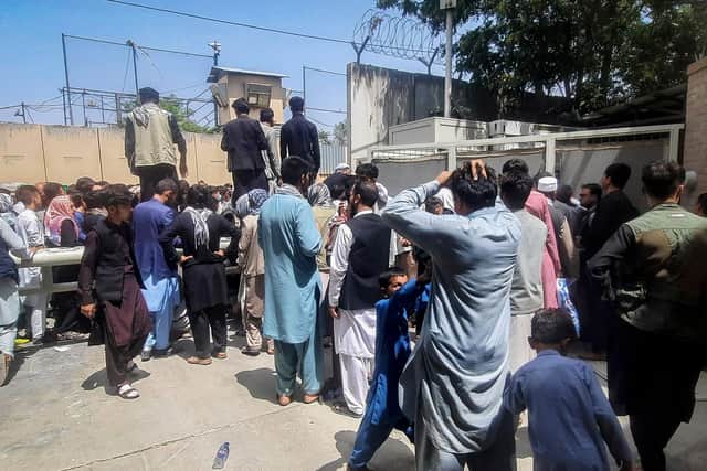Afghan people gather outside the French embassy in Kabul on August 17, 2021 waiting to leave Afghanistan. Photo by Zakeria Hashimi/AFP via Getty Images