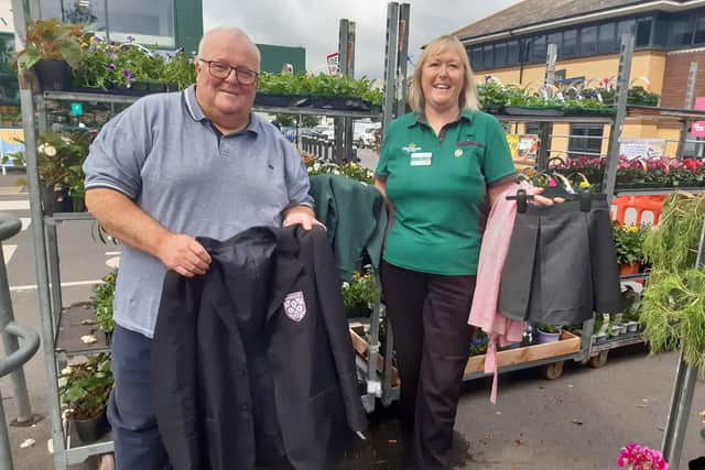 Mike Northeast, who represents Courtwick with Toddington ward on Arun District Council and Wickbourne on Littlehampton Town Council, and Alison Whitburn, community champion at Morrisons Littlehampton, with items of uniform that have been donated for the swap shop