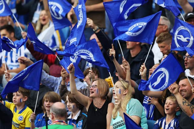 BRIGHTON, ENGLAND - AUGUST 21: Brighton and Hove Albion fans wave flags as they show their support prior to the Premier League match between Brighton & Hove Albion  and  Watford at American Express Community Stadium on August 21, 2021 in Brighton, England. (Photo by Eddie Keogh/Getty Images) SUS-210823-153230002