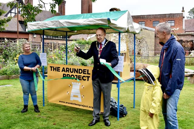 The opening of Arundel Bee Project's Pollinators Garden, from left, Arundel Town Council clerk Carolyn Baynes, Arundel mayor Tony Hart, six-year-old Kiran De in a beekeeper suit and project founder Nick Field