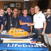 Former coxswain Steve Smith, left, congratulates the new coxswain-mechanic Simon Williams, watched by crew members at Shoreham RNLI. Picture: Derek Martin DM21081089a