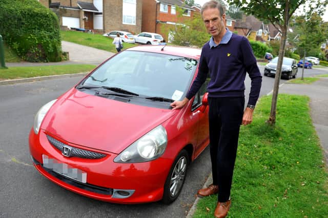 Miles Clarke with the car that had its catalytic converter stolen. Picture: Steve Robards, SR2108311.