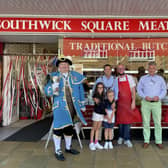 Stephen Chipp, chairman of Adur District Council with his children and Worthing town crier, Bob Smytherman, outside Southwick Square Meets in Southwick