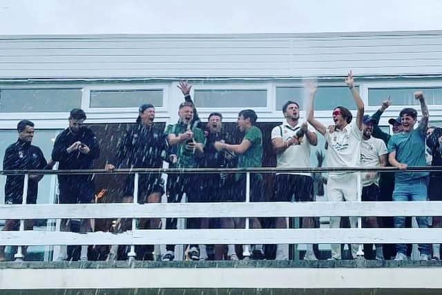 Celebrations on the balcony after promotion is secured