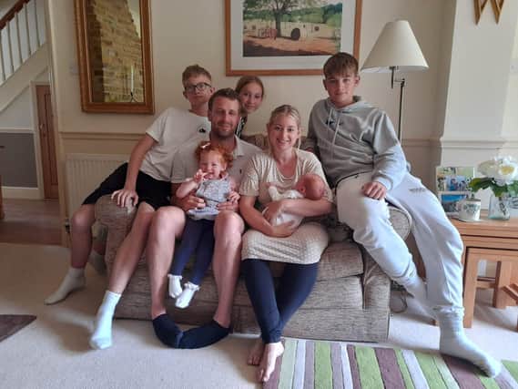 Laura Sneller and her family SUS-210209-083227001