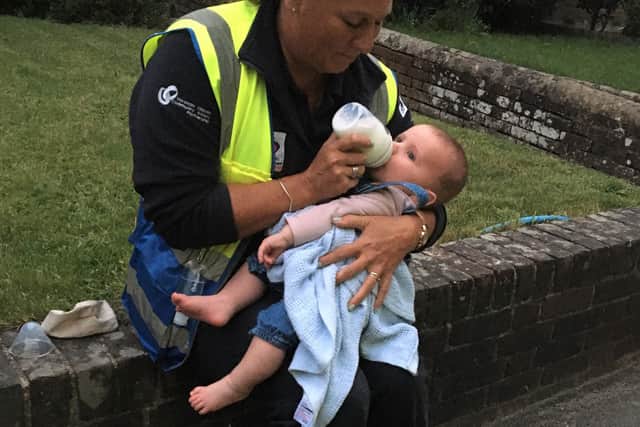Neighbourhood Warden Vanessa Green with baby Dominic at the accident scene