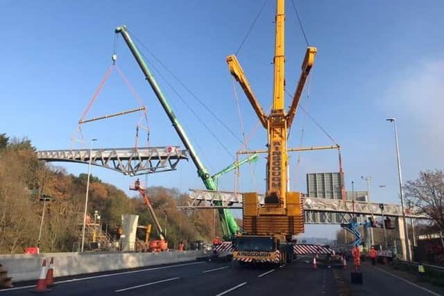 The new East Street footbridge spanning the M20 in Kent being lifted into place last year