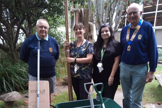President David Cook of Littlehampton Lions on the right, together with colleague David Bishop and staff members from the White Meadows Primary Academy, at the presentation. The club gifted the school with brand new gardening equipment for a school project