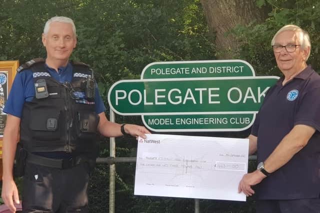 Richie Davidson from Sussex Police handing the donation over to Derek Wait from the Polegate and District Model Engineering Club. Picture from Sussex Police SUS-210709-140043001