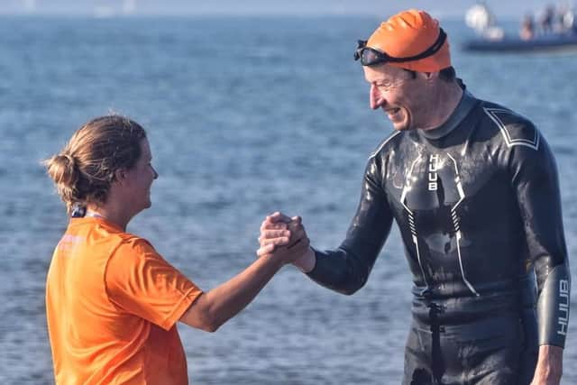 Handshakes to celebrate after the 5km Solent Swim in support of Cure Parkinson's. Photo by Ian Dickens