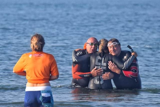 Some of the Positively Parkinson's swimmers embracing after their 5km swim from Gosport to Ryde in the Isle of Wight. Photo by Ian Dickens