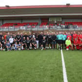 The Brighton and Worthing teams line up for the memorial match