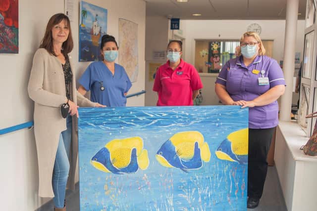 Painter Christine Bleny (far left) with ward matron Julie Baker (far right) and the Peanut Ward nursing staff at Queen Victoria Hospital. Picture by the Trust Medical Photographer