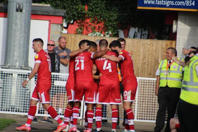 The Reds celebrate their late winner. Photo: Cory Pickford