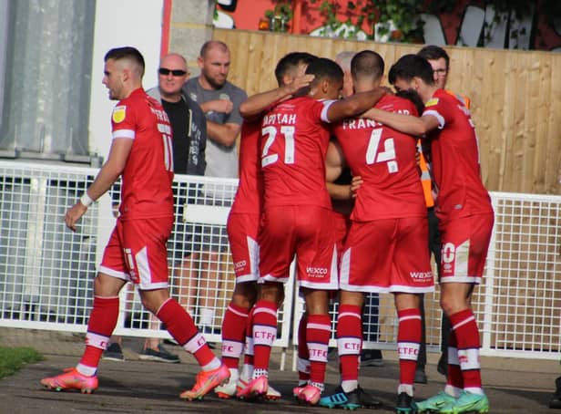 Crawley Town players celebrate with matchwinner Nick Tsaroulla. Picture by Cory Pickford